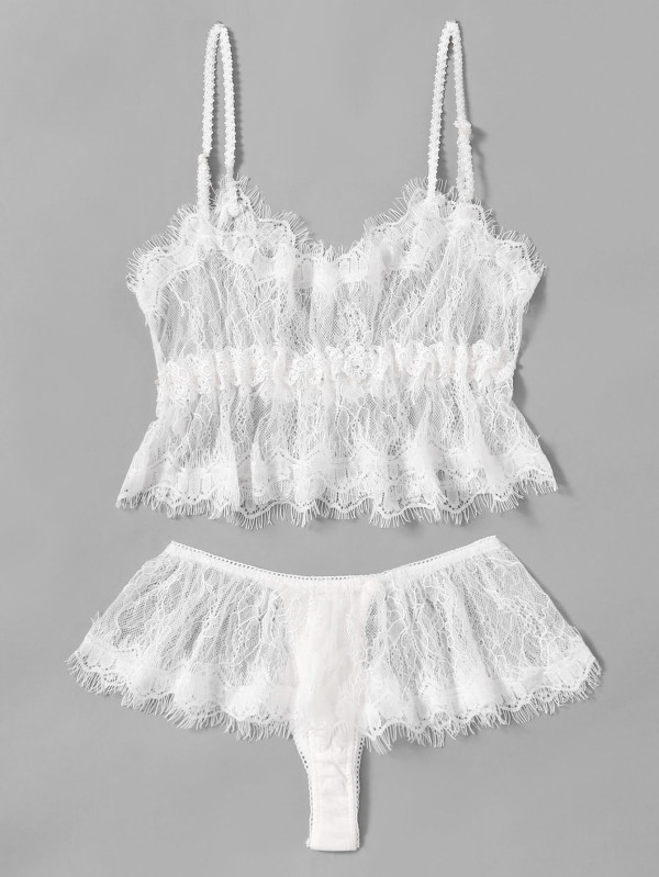 2 piece white eyelash lace lingerie set. A spaghetti strap top that is fitted at the breast area and flows to above the navel. A white thong with a lace ruffle at the top